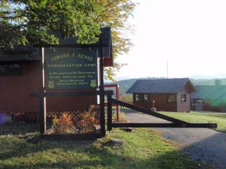 Camp Kehoe sign and cabin